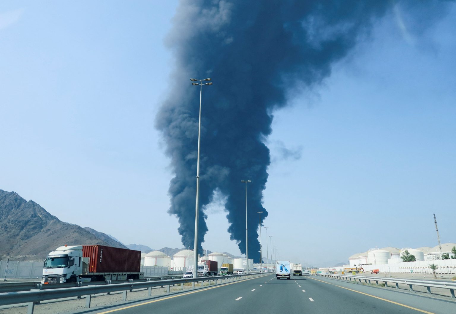 Smoke rises in the Fujairah oil industry zone, caused by debris after interception of a drone by air defences. Photo: Staff/Reuters