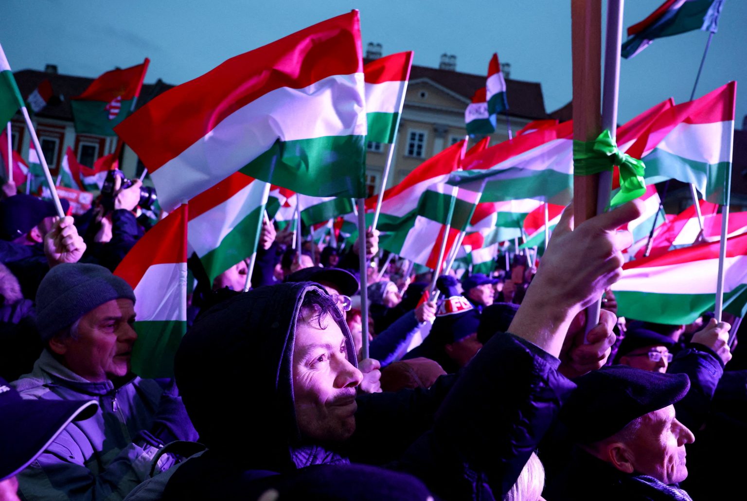 Supporters wave Hungarian flags at a campaign rally as the election battle intensifies. Photo: Bernadett Szabo/Reuters