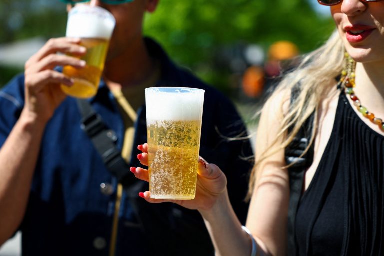 People hold beers.